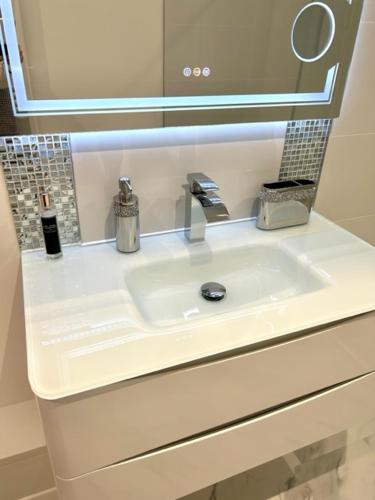 a white sink in a bathroom with a mirror at The Quay in Newhaven