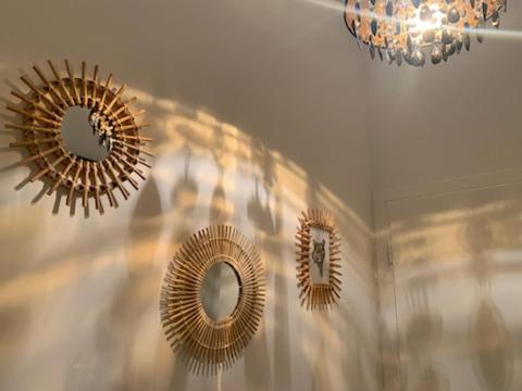 three mirrors hanging on a wall in a room at Logement Le Bois Le Prêtre Pont-à-Mousson in Pont-à-Mousson