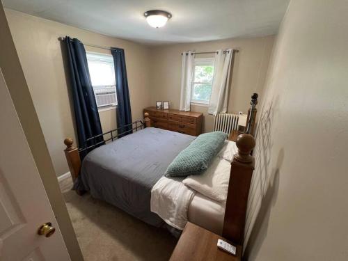 a small bedroom with a bed and a window at The Purple Door apt in the heart of Radford city in Radford