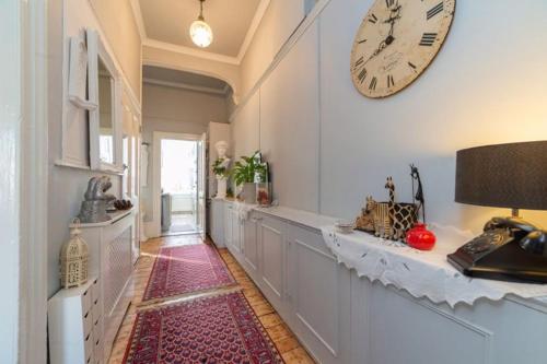 a hallway with a large clock on the wall at Elgin Terrace in London