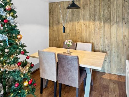 a dining room with a christmas tree and a wooden table at Location, Location, Location with King Size Bed in Kent