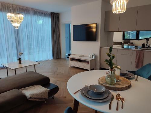 a living room with a couch and a table at Luxe chalet 79 in Ružomberok