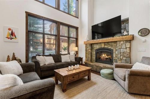 a living room with couches and a fireplace at Pinnacle Ridge Luxury Condo 2 in Whitefish