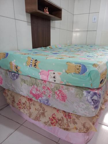 a bed with hello kitty sheets on top of it at Kitnet Apartamento Praia Matinhos in Matinhos
