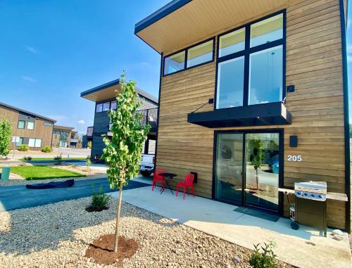 a house with a tree in front of it at Red Poppy at the Quarry in Whitefish