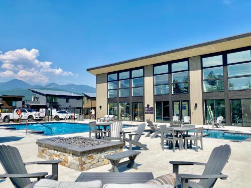 a patio with tables and chairs next to a pool at Red Poppy at the Quarry in Whitefish