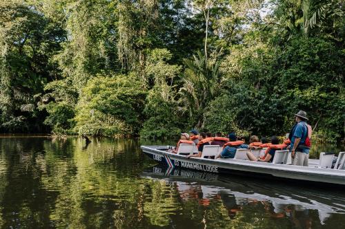 a group of people on a boat on the water at Mawamba Lodge in Tortuguero