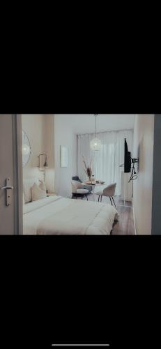 a bedroom with a large bed and a table at Suite Onega in Lyon