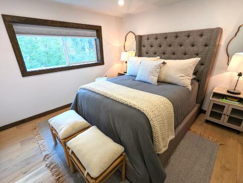 - une chambre avec un grand lit et une fenêtre dans l'établissement Tall Timbers Cabin, à West Glacier