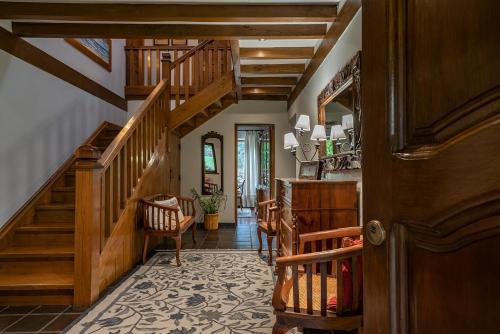 a hallway with wooden stairs and a stair case at Excepcional Casa El Olivo in Ojedo