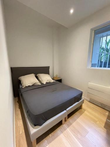 a bedroom with a bed in a room with a window at Les pieds dans l’eau in Cassis