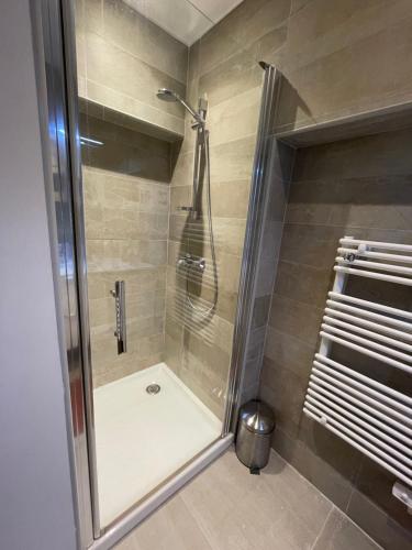 a shower with a glass door in a bathroom at Les pieds dans l’eau in Cassis