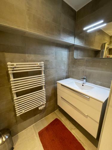 La salle de bains est pourvue d'un lavabo et d'un miroir. dans l'établissement Les pieds dans l’eau, à Cassis