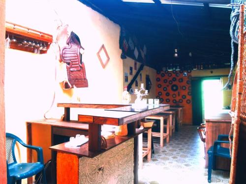 a restaurant with tables and chairs in a room at Shirma Nua Chaucha in Cuenca