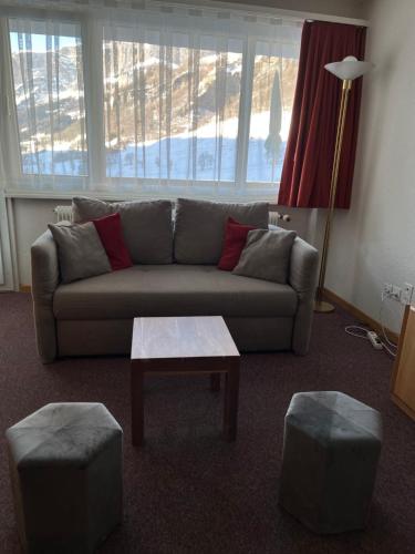 a living room with a couch and a coffee table at Haus Atlantic Leukerbad in Leukerbad