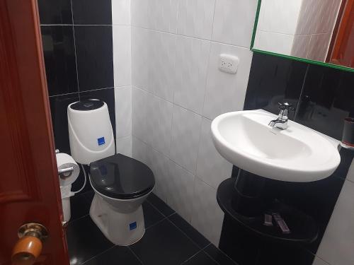 a bathroom with a sink and a toilet at Hotel Neiva Providencia in Neiva