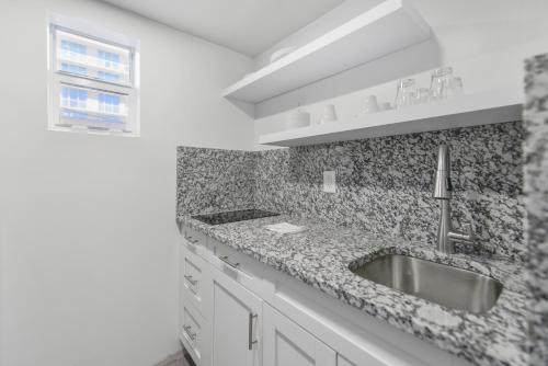 a white kitchen with a sink and a window at Beachfront Getaway Studio with Parking - M21 in Hollywood