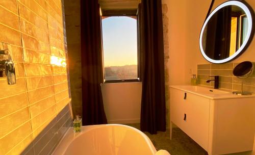a bathroom with a sink and a toilet and a window at DOMAINE DE LEJOS - Portes d'Albi in Lamillarié