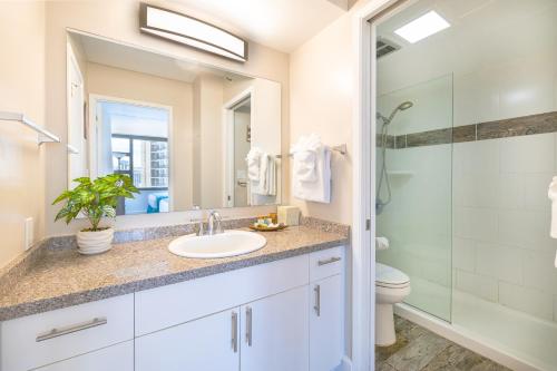 a bathroom with a sink and a shower at Aloha Vibes, Ocean & City Views with Free Parking! in Honolulu