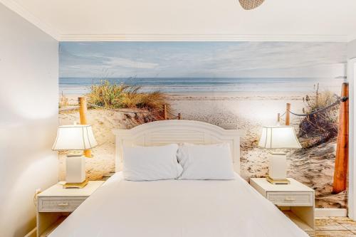 - une chambre avec un lit et une peinture sur la plage dans l'établissement Beachview 208, à Gulf Shores