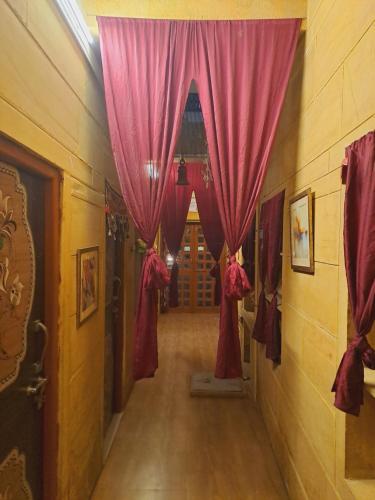 a hallway with red curtains in a building at Bob Cafe & Guest House Jaisalmer in Jaisalmer
