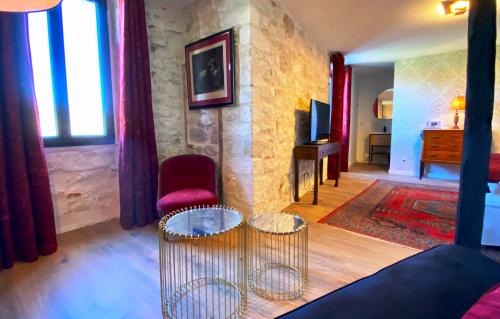 a living room with a couch and a table and chairs at DOMAINE DE LEJOS - Portes d'Albi in Lamillarié