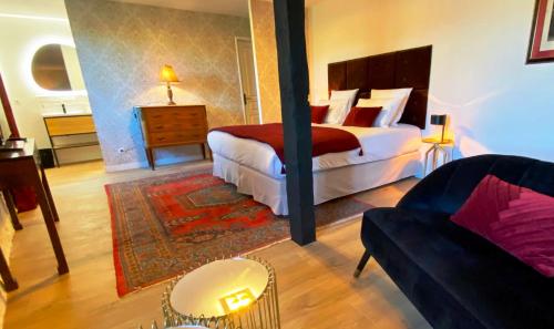 a hotel room with a bed and a couch at DOMAINE DE LEJOS - Portes d'Albi in Lamillarié