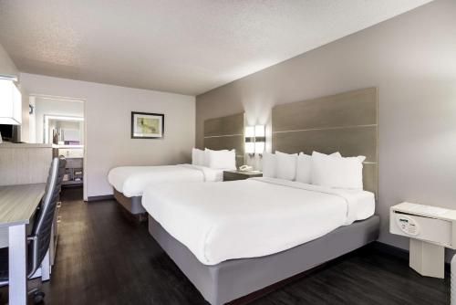 a hotel room with two beds and a kitchen at SureStay Hotel by Best Western Grants in Grants