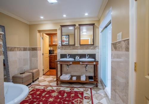 a bathroom with two sinks and a walk in shower at Hotel Dushore in Dushore