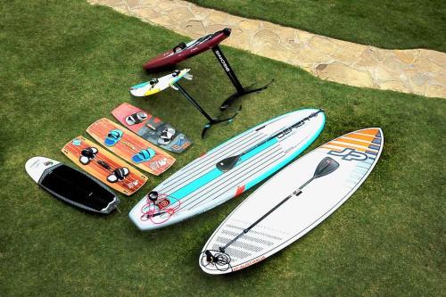 a group of surfboards on display on the grass at CABARETE BEACH HOUSES the NANNY ESTATES in Cabarete