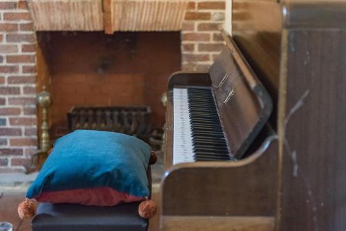 a pillow sitting on top of a piano at Craythornes by Bloom Stays in New Romney