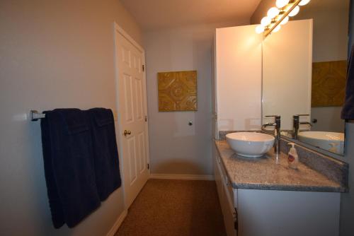a bathroom with two sinks and a blue towel at Grant's Condo in The Greens in Branson