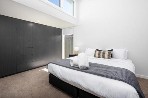 a bedroom with a large bed and a window at New luxury home, walking distance to CBD in Wagga Wagga