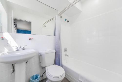 a white bathroom with a toilet and a sink at The Mariner Suites #26 in Hollywood
