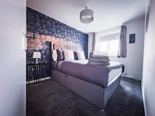 a bedroom with a bed with a brick wall at The Fairfield - Free Parking & Wi-Fi - 5min to Freeman Hospital in Longbenton