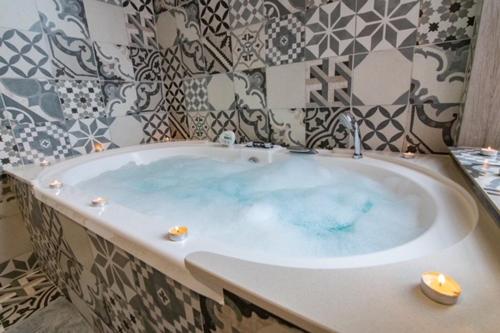 a bath tub with blue water in a bathroom at San Pedro in Pontevedra