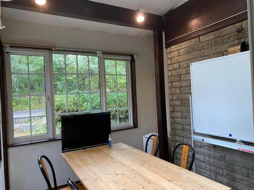 a conference room with a table and a white board at Klingelbaer in Hakone