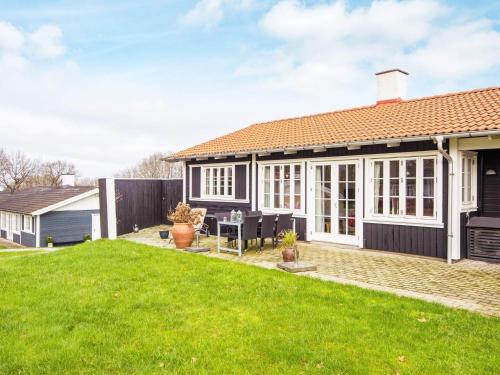 a detached house with a patio and lawn at 6 person holiday home in Aabenraa-By Traum in Aabenraa