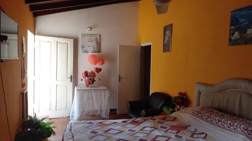 a bedroom with a bed and a table with balloons at Hospedaje Luque in Luque