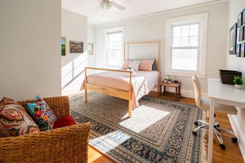 a bedroom with a bed and a desk in a room at Globetrotters Suite in Historic Richmond with Patio in Richmond