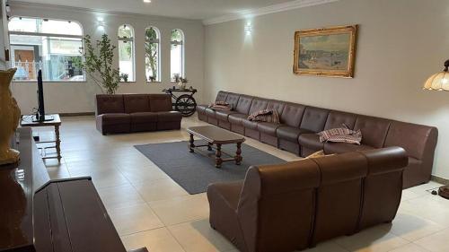 a living room with a couch and a table at Hotel Regência in São Lourenço