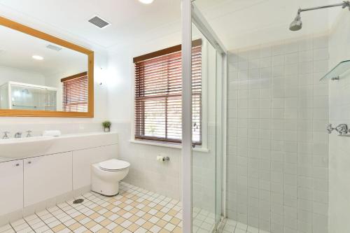 a bathroom with a toilet and a sink and a shower at Villa 2br Barbera Villa located within Cypress Lakes Resort in Pokolbin