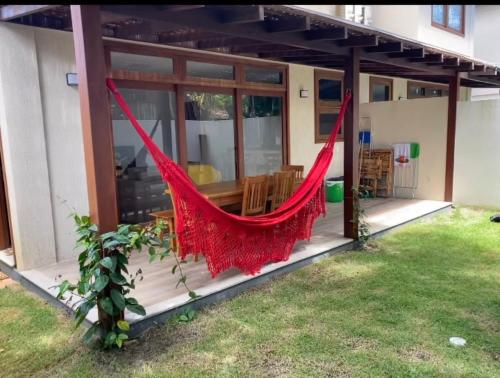 a hammock on the porch of a house at Condominio Viva Barra in Barra Grande