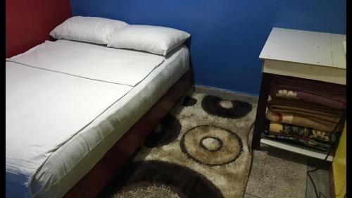 Dormitorio pequeño con cama y mesa en Studio tan tan, en Tan-Tan Plage