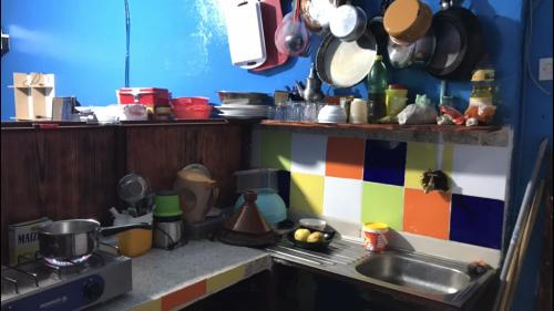 a cluttered kitchen with a sink and a stove at Studio tan tan in Tan-Tan Plage