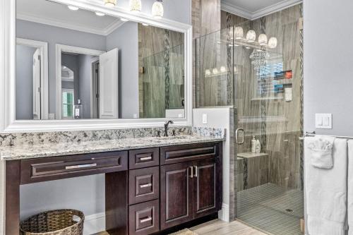a bathroom with a shower and a sink and a mirror at Sunrise Bay in Cape Coral