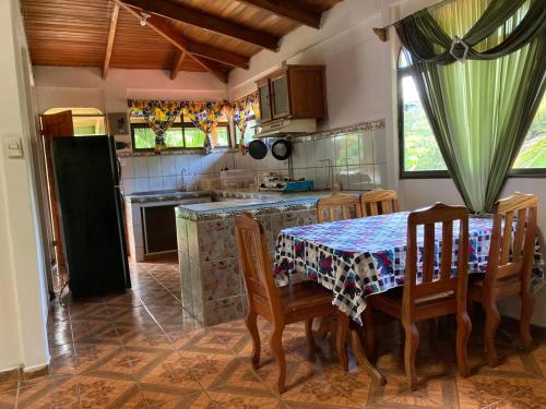 a kitchen with a table and chairs and a kitchen with a stove at Betania House in Drake