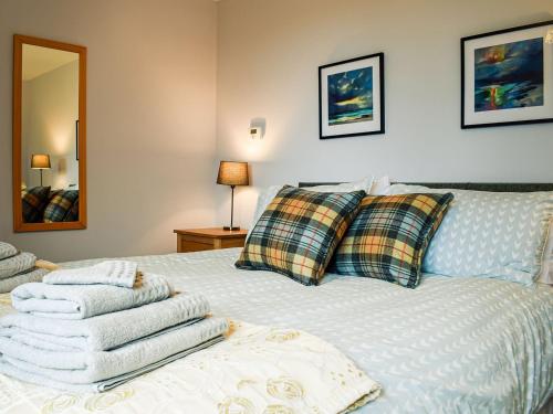a bedroom with a bed with towels on it at Sheildaig Cottage Annex in Laurencekirk