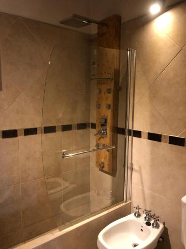 a bathroom with a shower and a toilet and a sink at Agrippina in Villa Carlos Paz