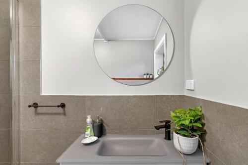 a bathroom with a sink and a mirror at Quite, quaint & private guesthouse, sleeps 6 in Melbourne